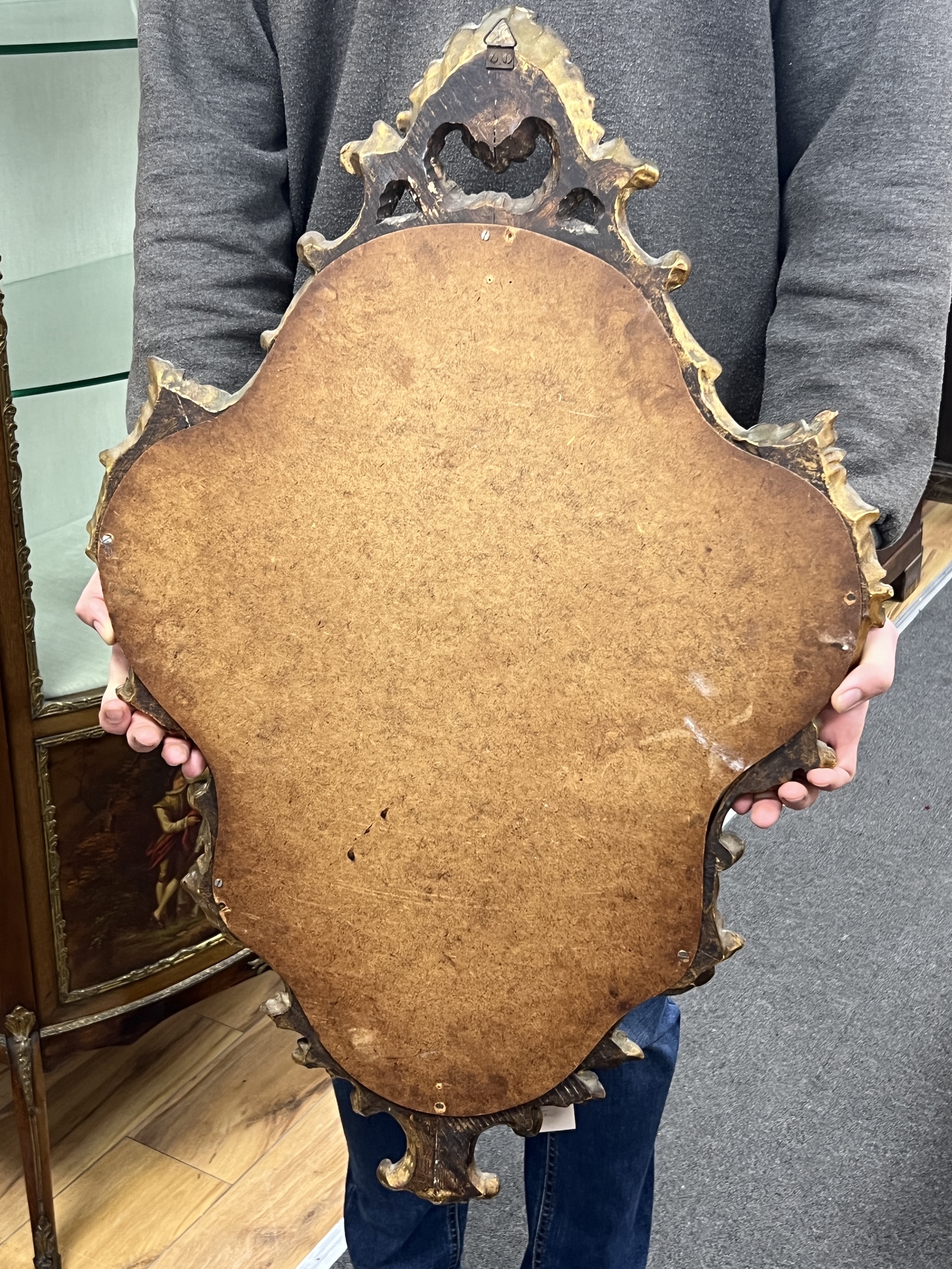 An 18th century style carved wood cartouche wall mirror, width 49cm, height 76cm